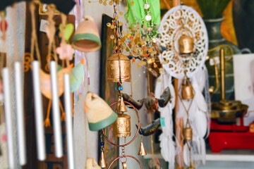 Colorful wind chimes on the with a bells background of a light blue door in the old city of Safed. In Israel in a spectacular antique store