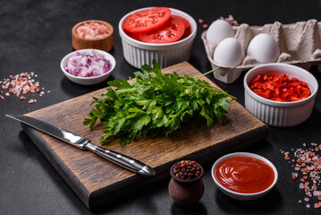 Ingredients for making shakshuka, dishes with fried eggs with tomato sauce, spices and herbs