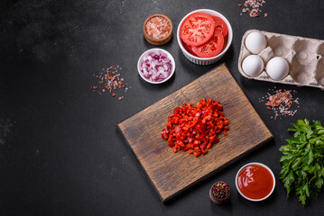 Ingredients for making shakshuka, dishes with fried eggs with tomato sauce, spices and herbs