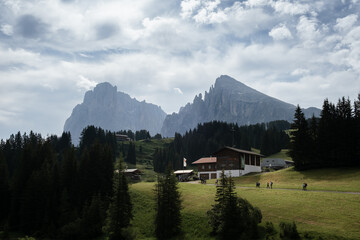 The cable car Florian at the Seiser Alm with the mountain Langkofel and Plattkofel in the background. - obrazy, fototapety, plakaty