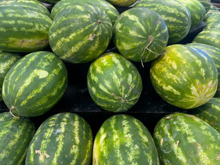 Large watermelons on display at a supermarket
