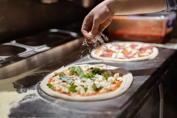  Pizza making process. Male chef hands making authentic pizza in the pizzeria kitchen. © arthurhidden