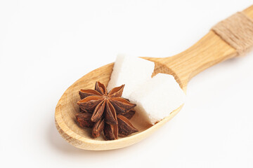 wooden spoon with two pieces of sugar and anise star