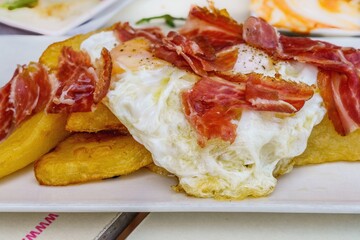 Scrambled eggs, fried in plenty of olive oil, fried potatoes and ham, very common in Spanish...