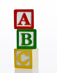 A, B and C wooden alphabet blocks on white background