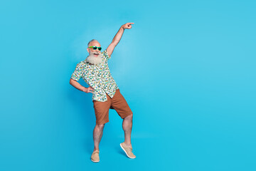 Full length photo of old excited grandfather dancing celebrating touch waist green glasses finger point new shopping mall isolated on blue color background