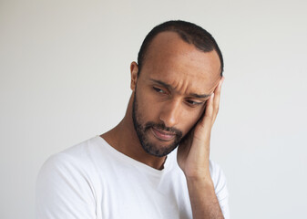 Fototapeta premium Stressed young african american man feel pain having terrible strong headache concept