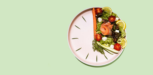 intermittent fasting concept plate as a clock with salad, salmon, fish and vegetables, tomato, lemon - obrazy, fototapety, plakaty