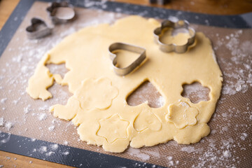 cutting out cookie dough with hands