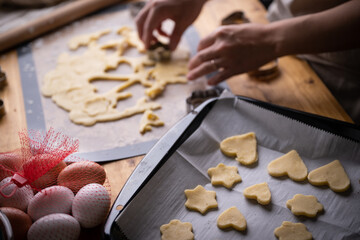 cutting out cookie dough with hands