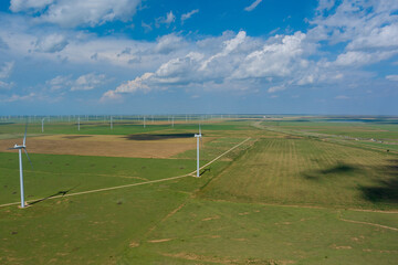 This is wind power electricity farm row of windmill renewable energy turbines in the country of Texas, USA.