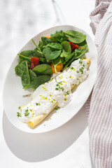 Breakfast Scrambled eggs with stracciatella and vegetable salad on white background for restaurant menu.