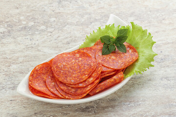Sliced pepperoni sausage in the bowl