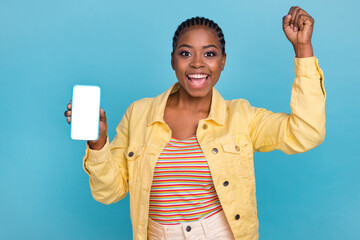 Portrait of attractive trendy cheerful girl using device copy space rejoicing isolated over bright...