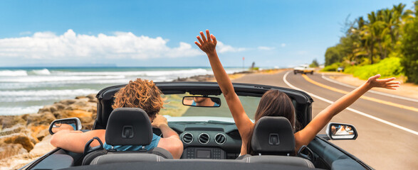 Road trip summer vacation fun young couple driving convertible car on holiday travel destination banner panoramic. Woman with arms up happy, man driver having fun. - obrazy, fototapety, plakaty