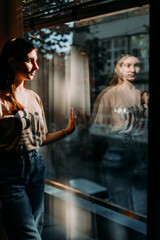 reflection of adolescent in the window