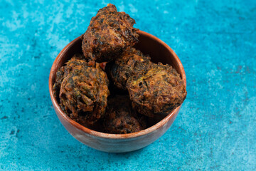 Indian spicy vegetable pakora or pakoda served in dish isolated on table top view