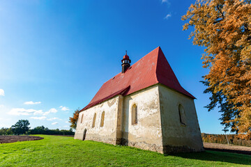 Fototapeta premium Old church in the autumn field. Dobronice u Bechyne, Czech republic.