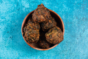 Indian spicy vegetable pakora or pakoda served in dish isolated on table top view