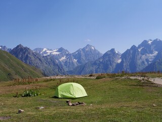 Camping tent at the Koruldi lakes, beautiful view of Great Caucasus mountains close to Mestia in Upper Svaneti, Georgia.