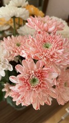 Cute small bouquet of chrisantemums. Close up of white, yellow and pink chrisantemums.