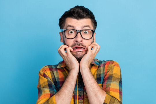 Photo Of Impressed Handsome Terrified Guy Dressed Eyeglasses Checkered Shirt Staring At Camera Big Eyes Isolated On Blue Color Background