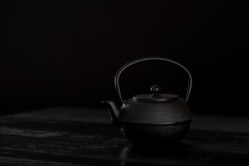 teapot on black background