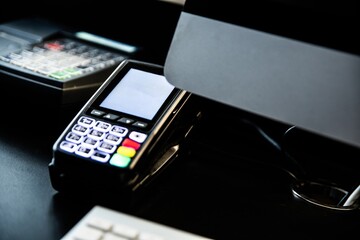 Payment card terminal on the desk with an empty space for a message on the display.