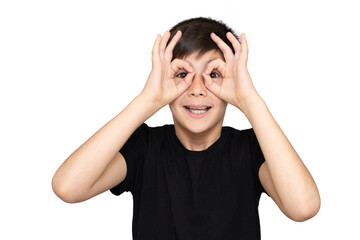 Fototapeta premium A 9-year-old boy in a black t-shirt on a white background and depicts a monkey