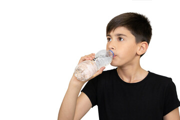 Photo of adorable young happy boy looking at camera.Child drinking pure water on the white background.