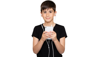 Cheerful young boy listening to the music in headphones and mobile phone isolated over white background