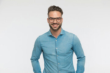sexy casual guy wearing eyeglasses, smiling at the camera