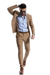 arrogant young man in brown suit holding hand behind head