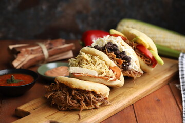 arepa lunch or breakfast from colombia or venezuela filled with traditional ingredients - obrazy, fototapety, plakaty