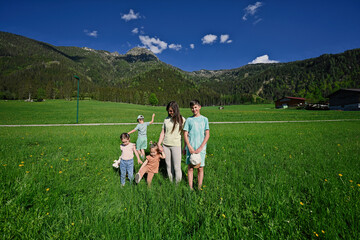 Mother with four children  in alpine meadow at Untertauern, Austria.