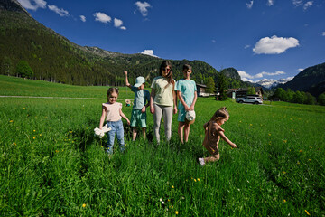 Mother with four children  in alpine meadow at Untertauern, Austria.