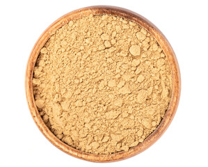 Top view of ground ginger root powder in a wooden bowl.