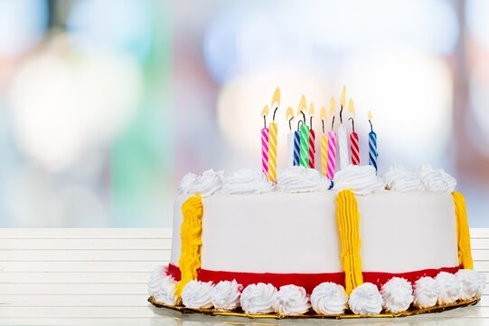 Extravagant Birthday Cake With Lots Of Birthday Candles Against A Background