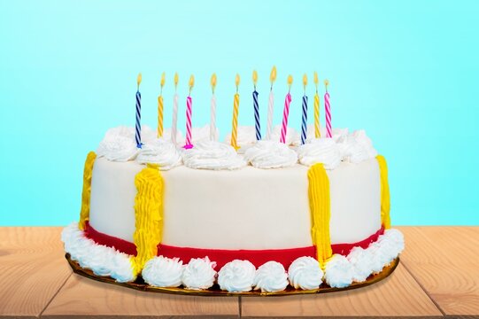 Extravagant Birthday Cake With Lots Of Birthday Candles Against A Background