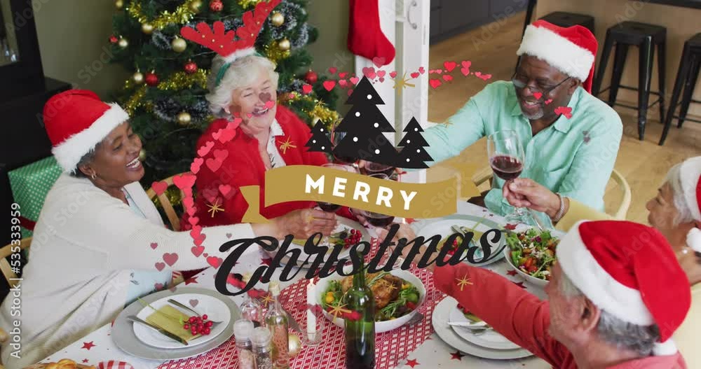 Sticker Animation of merry christmas over happy diverse senior friends in santa hats eating together