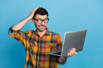 Photo of ceo brunet guy look laptop wear eyewear plaid shirt isolated on blue color background