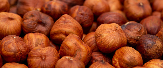 Heap of hazelnuts close-up. Peeled nuts. Hazelnut isolated on white background.
