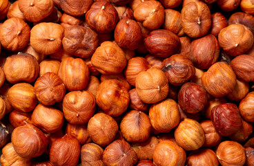 Heap of hazelnuts close-up. Peeled nuts. Hazelnut isolated on white background.