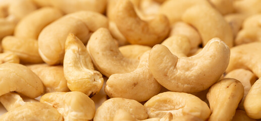 Cashew nuts as a background, top view. Cashew isolated on white background. Healthy foods.