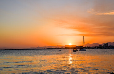 Naklejka na ściany i meble Beautiful colorful sunrise on the sea with bright orange color and sun