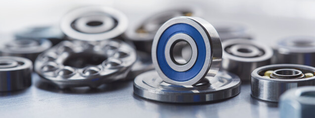 different bearings, vernier caliper and ruler on metal background. Part of mechanism.