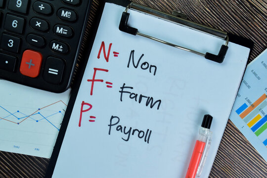 Concept of NFP - Non Farm Payroll write on paperwork isolated on Wooden Table.