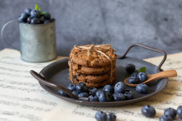 Homemade oatmeal cookies on a metal plate against the background of an old table. Healthy food concept. copy space.