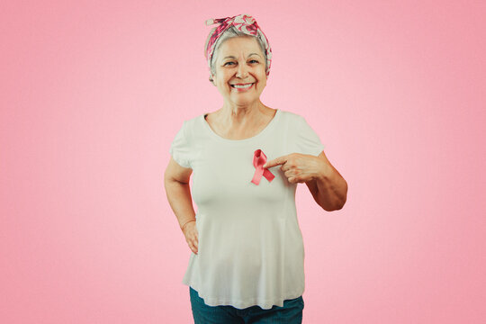 Mature Woman With Pink Ribbon Isolated, For Breast Cancer Campaign.