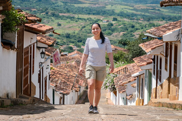 Young woman doing tourism in old town of Colombia, woman making selfie in colonial town, Barichara